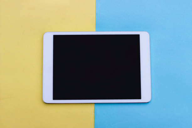 istock abstract colored paper, pastel yellow and blue background, empty tablet, mock up 998502242