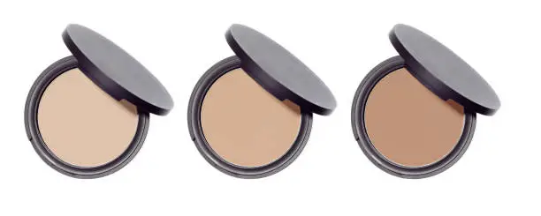 Compact pressed face shine control round powder isolated on white background. Set of three makeup cosmetics powders. Nude beige brown color skin blends.