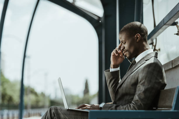 istock Smiling confident businessman working on laptop on city bench 998505162