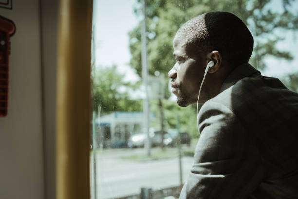 istock Stylish confident businessman listening to music while going to work by train 998505164