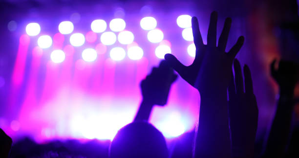 istock People dancing and cheering at festival 998513720