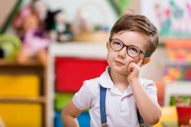 Preschooler Little boy planning in classroom. looking up photos stock pictures, royalty-free photos & images