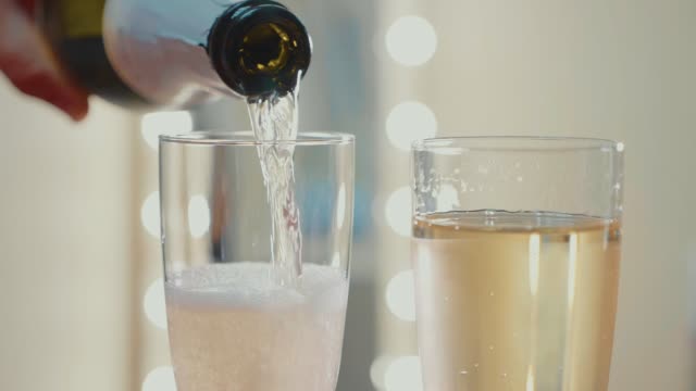 Champagne pouring from the bottle. Slow motion video