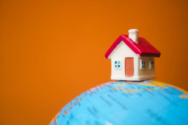 istock Miniature house on little planet 998527170