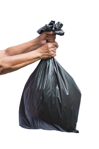 istock Cropped Hand Holding Garbage Bag Against White Background 998527688