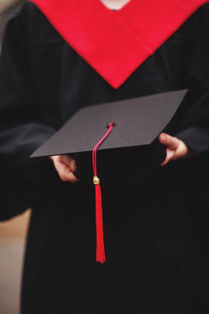 istock Midsection Of Male University Student Holding Mortarboard 998527930