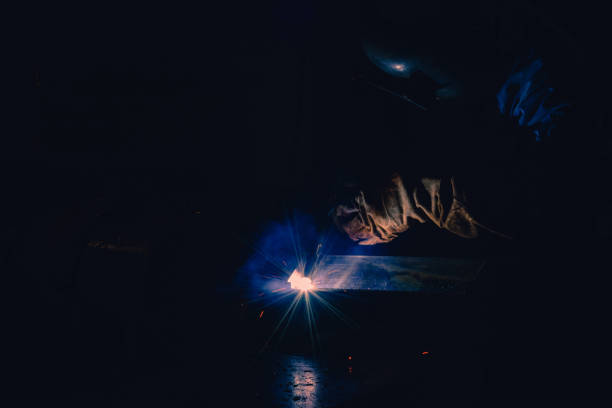 istock Welding steel structures and bright sparks in steel construction industry. 998533722