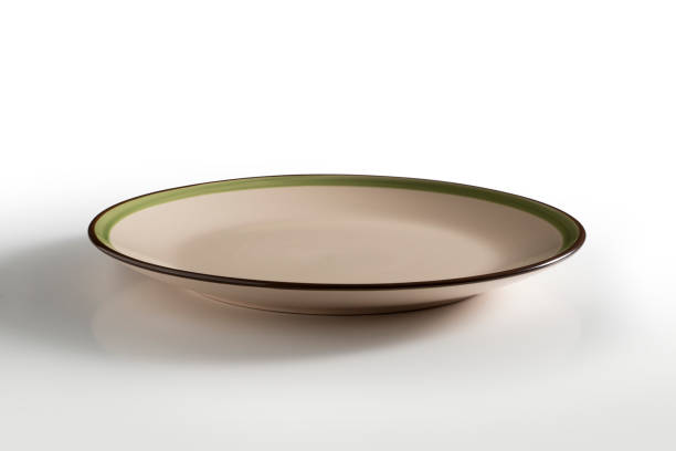 istock Beige round plate with green and brown border 998545864