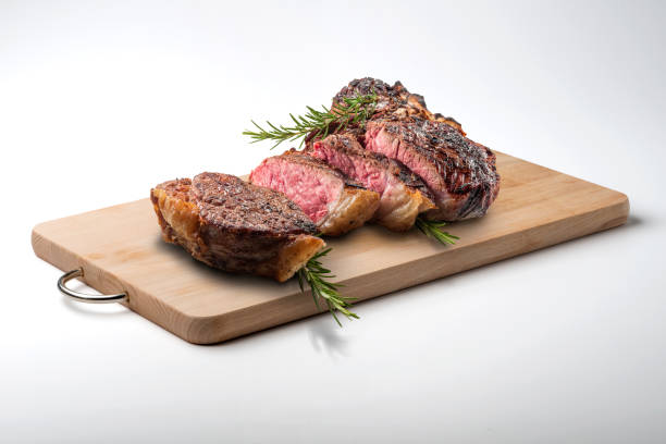 Fiorentina T-bone steak cut on rectangular wooden chopping board