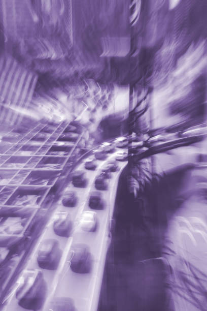 Traffic on a flyover in West Manhattan A long exposure of traffic queuing at a junction on a raised road in Manhattan. During the exposure the wide angle zoom lens has been zoomed to create a Kaleidoscope effect. city zoom out stock pictures, royalty-free photos & images