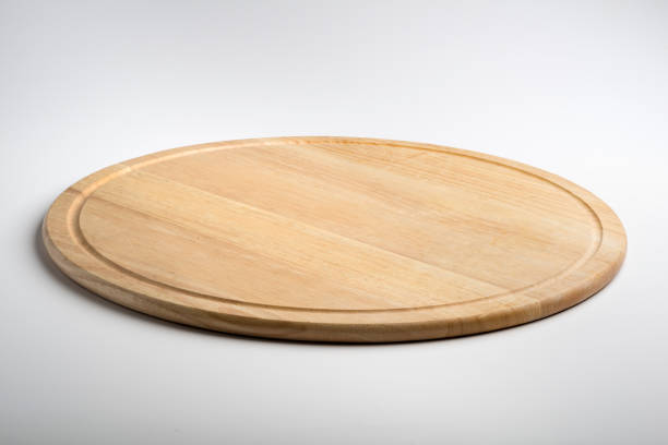 istock Isolated round wooden chopping board 998566368