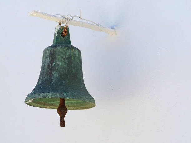 istock old greek metal church bell on white wall 998566970