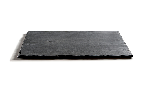 Square empty plate in black slate isolated on white background