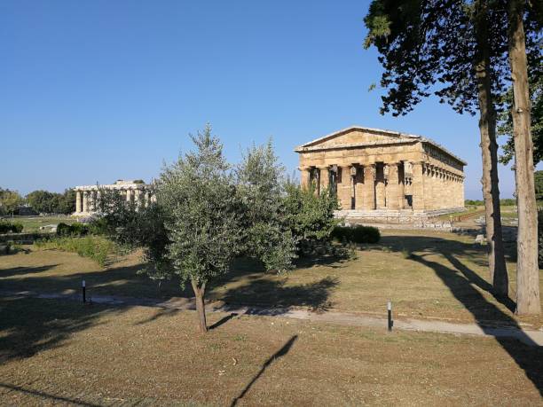 Temples of Paestum Paestum, Salerno, Campania, Italy - June 30, 2018: Temples of Hera and Neptune in the Archaeological Park of Paestum temple of neptune doric campania italy stock pictures, royalty-free photos & images