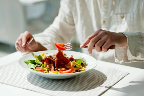 istock Midsection Of Person Holding Pasta In Restaurant 998568416