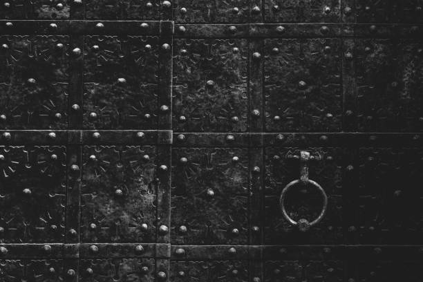Fragment of an old vintage door with knocking handle. Background.