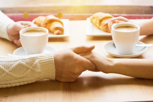 istock Close up young couple holding hands together 998573820