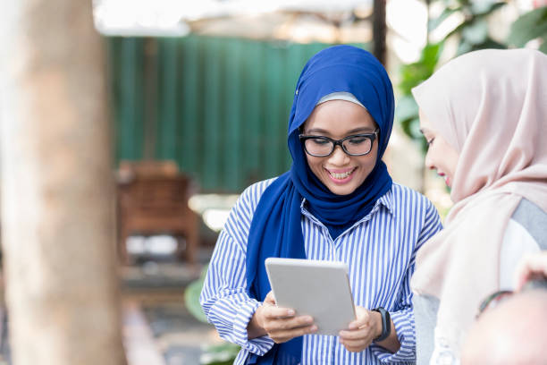 istock Cheerful friends looking at digital tablet 998587518