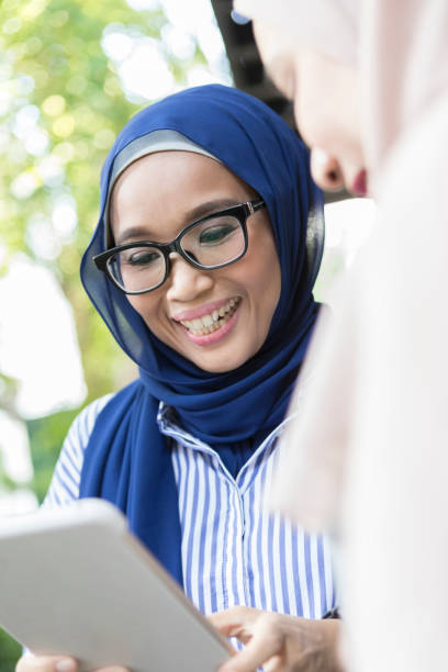 istock Mid adult Malaysian woman using digital tablet 998587718