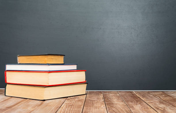 istock old books front of blackboard 998593628