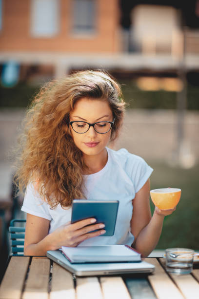 istock Female student sitting in cafe. 998593858