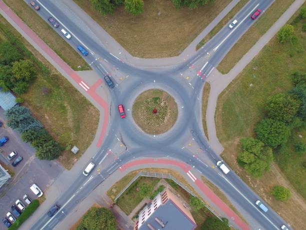 istock Roundabout intersection in four directions with island, aerial view 998594632