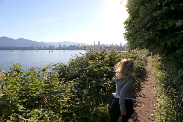 istock Girl jogs along path by the city 998594822