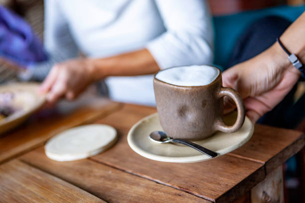 istock Waiter serving cappuccino in outdoor cafe 998595046