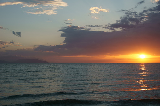 View of beautiful orange sunset over calm sea