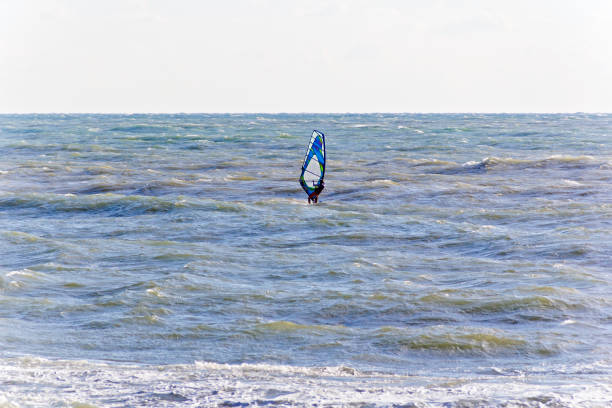 istock One surfer in open choppy sea 998597836