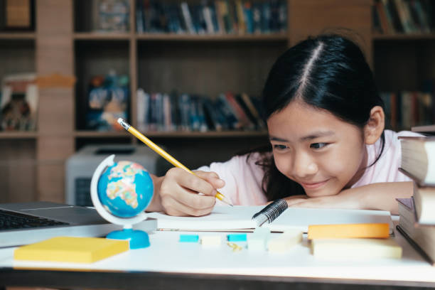 istock Girl reading and writing and do homework in library 998598270