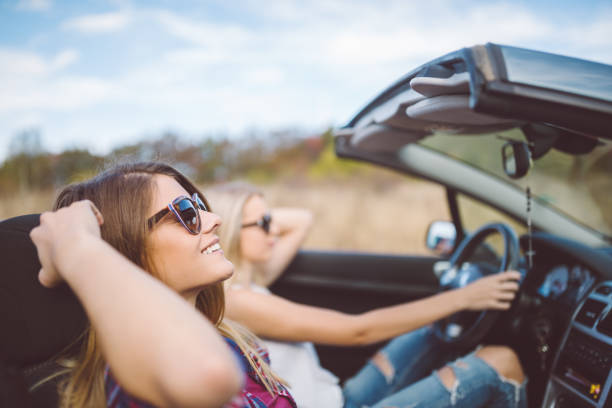 istock Young women on a road trip with cabriolet 998614194
