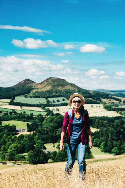 istock Active senior woman walking on a grass meadow 998633376