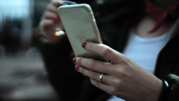 istock Woman looking at the phone and drinking tea 998646210