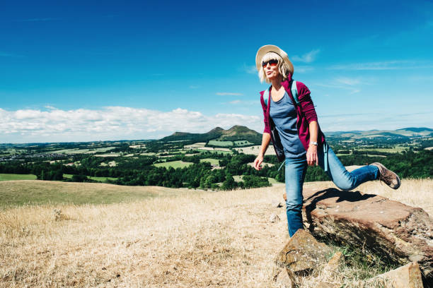 istock Active senior woman walking on a grass meadow 998648048