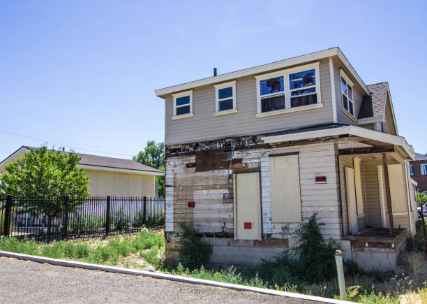 istock Abandoned Two Story Building With Boarded Up Doors 998651586