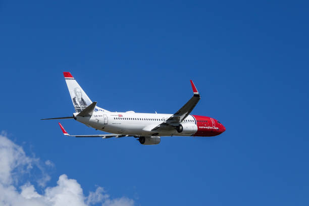 Arlanda, Stockholm, Sweden - July 10, 2018: Norwegian Air Shuttle ASA, Boeing 737 - 800 fly by in white clouds and blue sky at Stockholm Arlanda Airport / ARN. Jet aircraft / plane.
