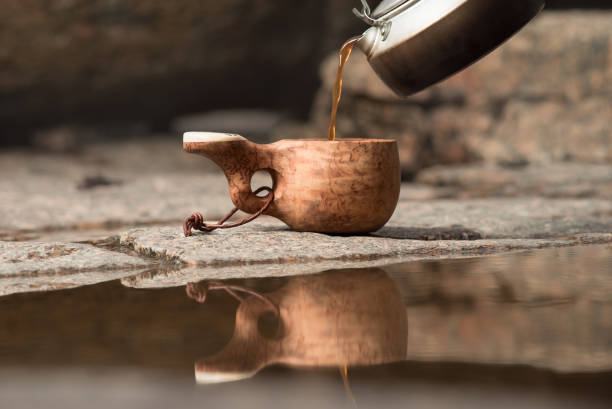istock A wooden mug on a granite stone. Handmade. Brown tones 998658792