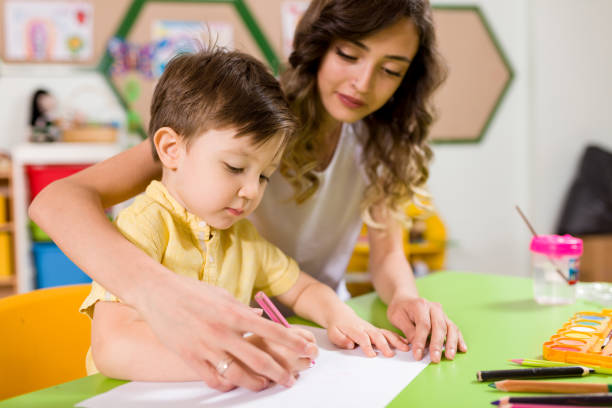 istock Preschool Student and Teacher 998663126
