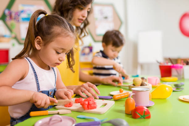 istock Childs are playing with play clay in classroom. 998667784