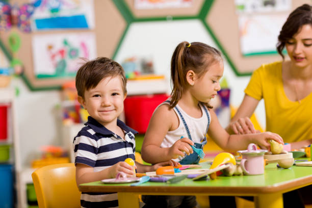 istock Childs are playing with play clay in classroom. 998668360