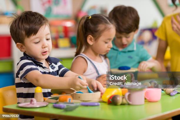 Childs Are Playing With Play Clay In Classroom Stock Photo - Download Image Now - Child, Preschool, Playing