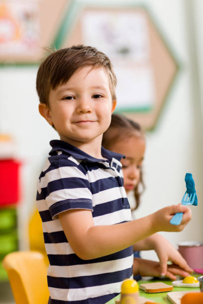 istock Childs are playing with play clay in classroom. 998670540