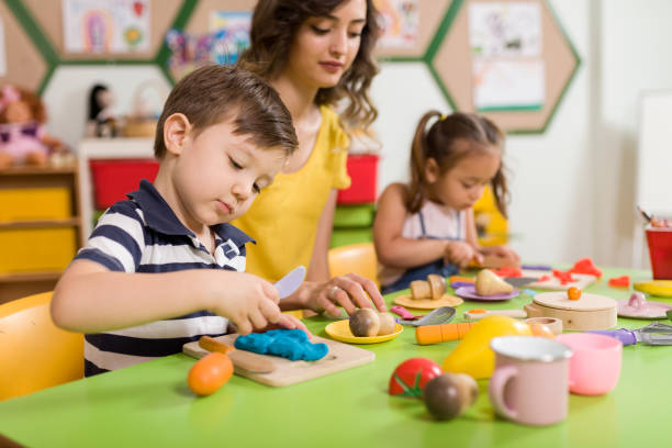 istock Childs are playing with play clay in classroom. 998670938