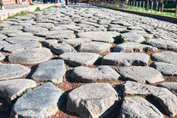 istock Rome, antique Roman road in cobblestones 998674844