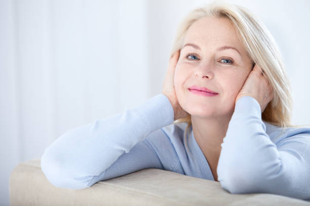 istock Active beautiful middle-aged woman smiling friendly and looking in camera. Woman's face closeup. Realistic images without retouching with their own imperfections. Selective focus. 998681338