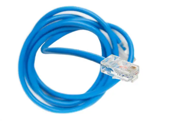 Photo of Twisted pair (patch cord) blue network Internet cable isolated over white background