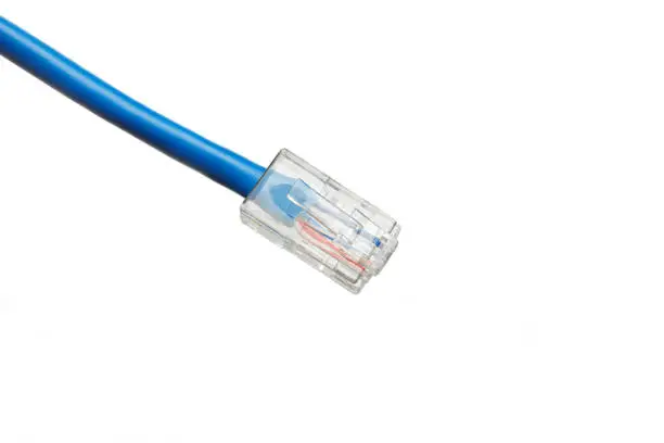 Photo of Twisted pair (patch cord) blue network Internet cable isolated over white background