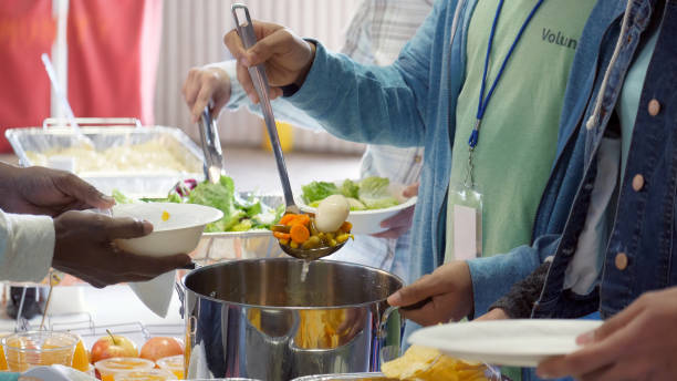 istock Unrecognizable volunteer serves soup in soup kitchen 998688312