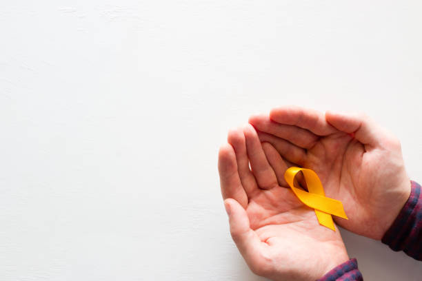 istock man holds a yellow ribbon on a white background with space for text 998688566